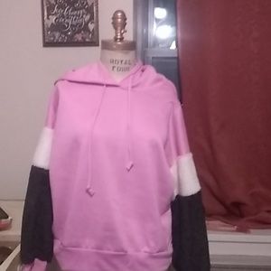 A pink hoodie with plush sleeves
